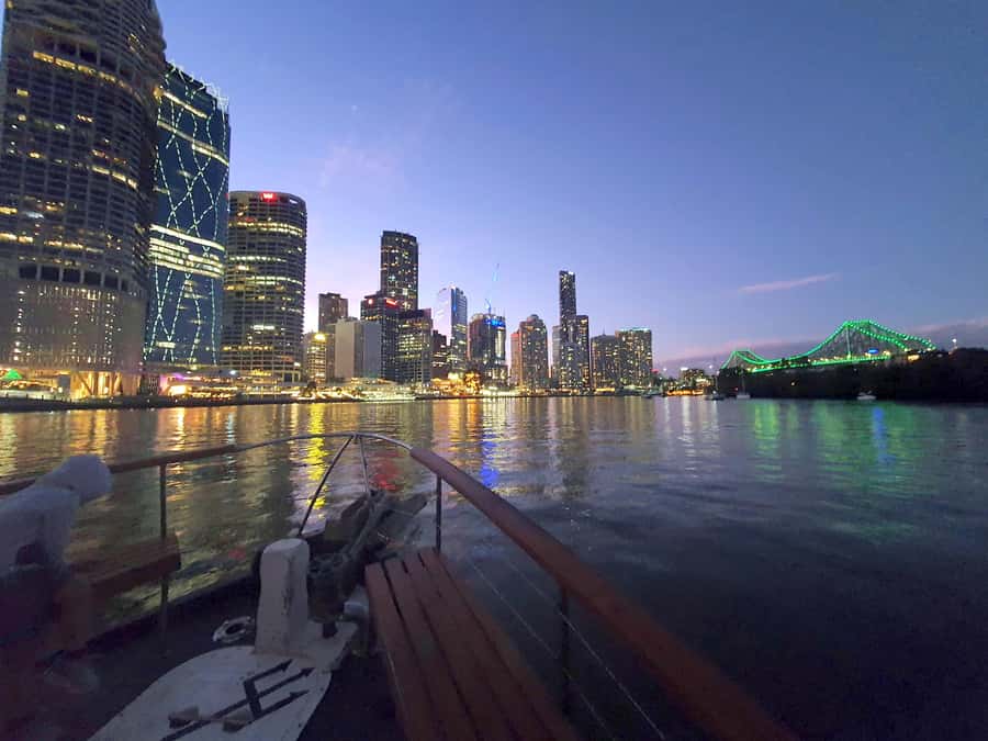 Brisbane: Sunset City Lights Cruise 5.30pm or 6pm <em>seasonal – Key points to know before you book’ /></p>
<ul>
<li><strong>Two seasonal departure times:</strong> Leave at 5:30pm from April through September, or 6pm from October through March.</li>
<li><strong>The light changes during the trip:</strong> You may begin in daylight and return with Brisbane lit up at night.</li>
<li><strong>Story Bridge and Kangaroo Cliffs are major sights:</strong> The river gives you a fresh angle on both.</li>
<li><strong>A charcuterie share board is included:</strong> Drinks and extra snacks cost more at the onboard bar.</li>
<li><strong>Music replaces commentary:</strong> Expect a calm cruise rather than a narrated tour.</li>
<li><strong>South Bank departure:</strong> Meet at the Cultural Centre Public Pontoon, 15 minutes before sailing.</li>
</ul>
<h2>Brisbane changes character as the sun goes down</h2>
<p><img width="900" height="675" decoding="async" src=